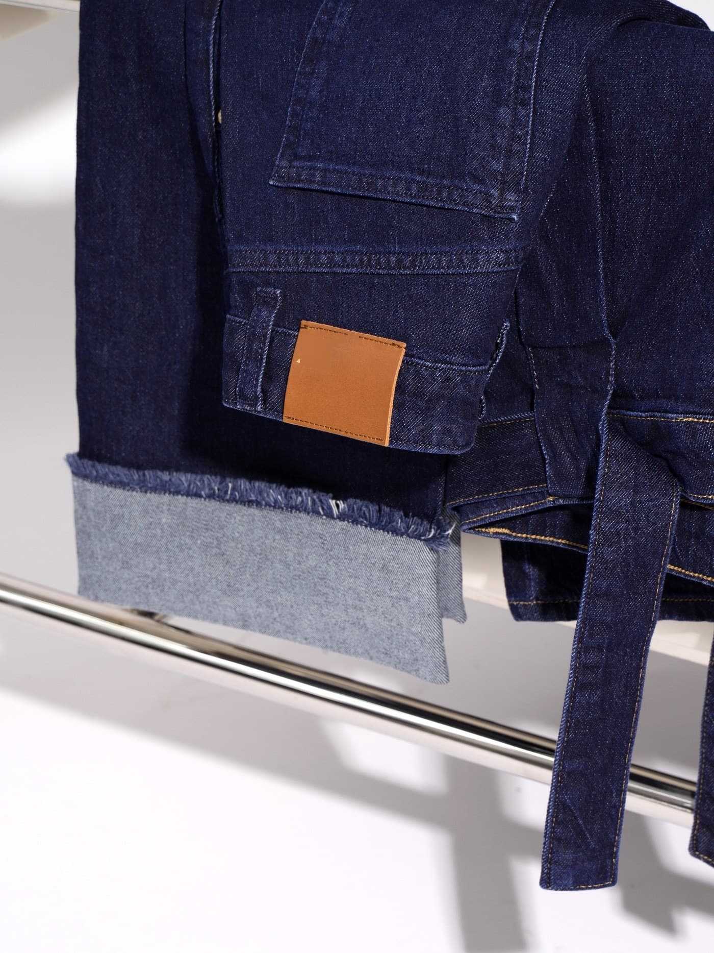 folded-cuff jeans with leather brand patch